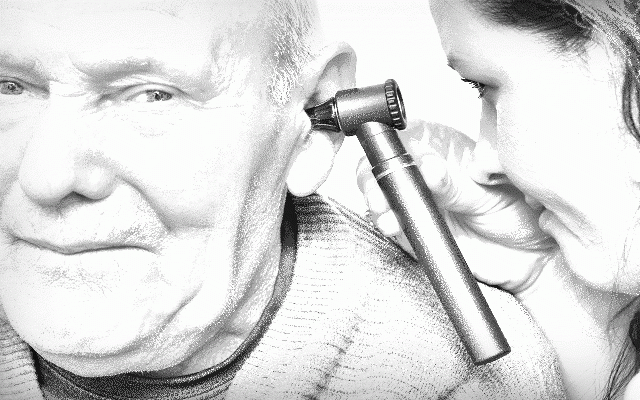 den Hörakustiker wechseln - Eine Hörakustikerin schaut einem Herrn mit einem Otoskop ins Ohr